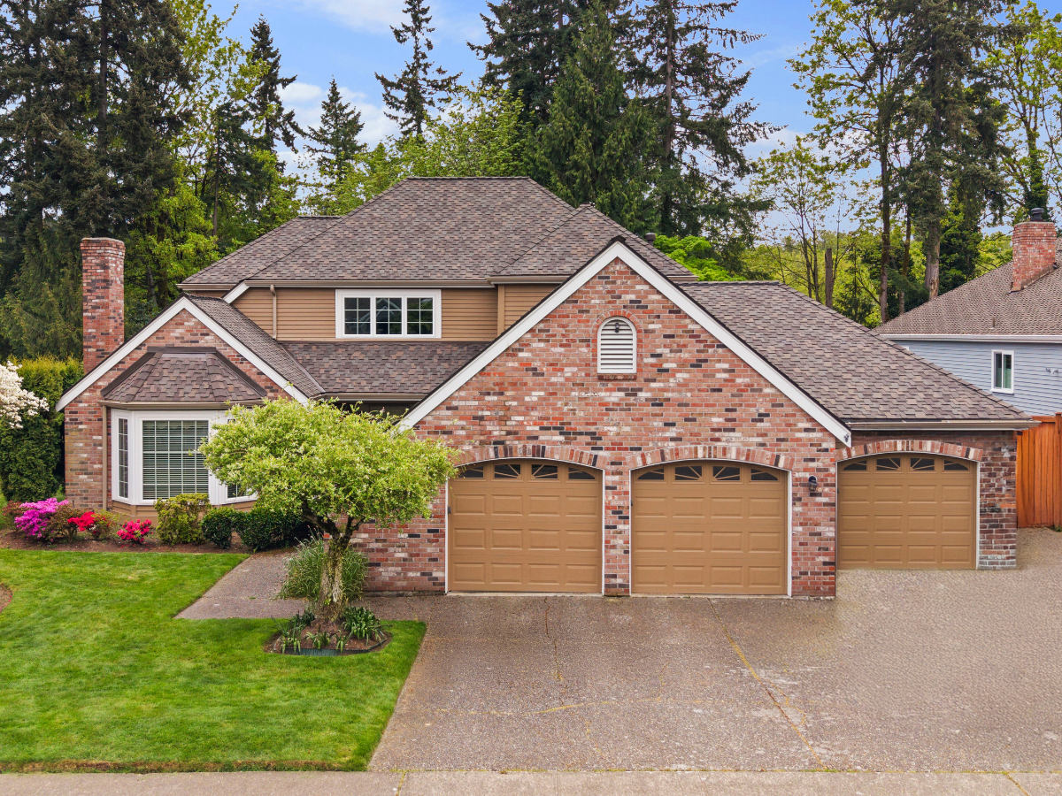 After roof replacement on a two-story brick home with new architectural shingles
